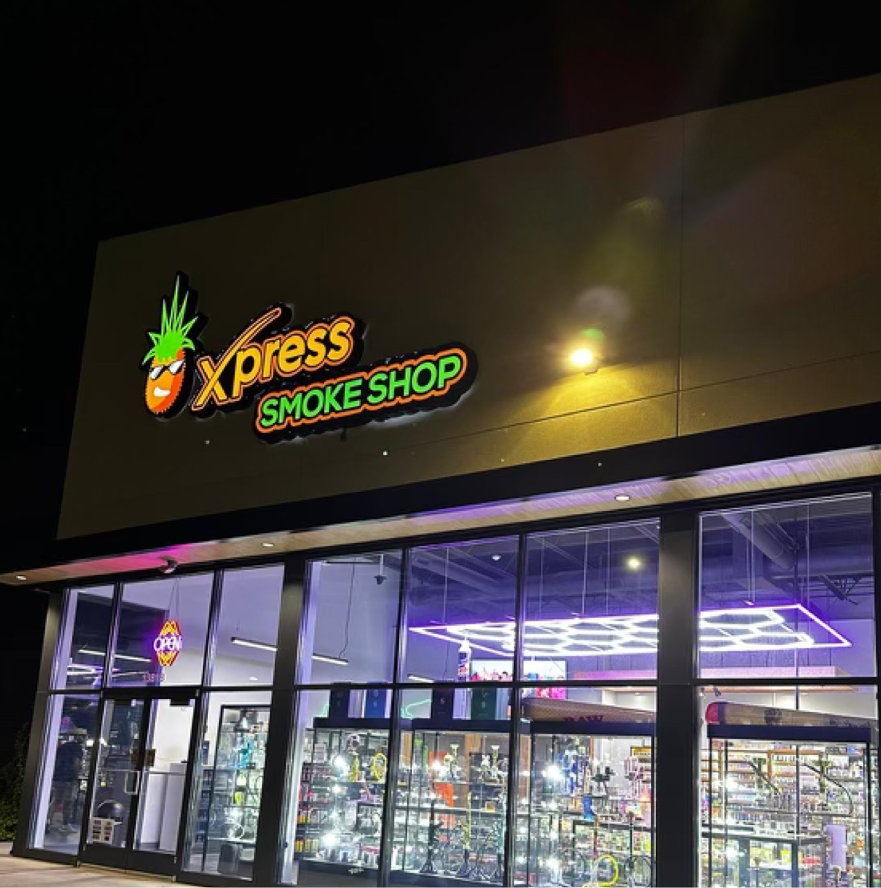 Xpress Smoke Shop storefront at night.